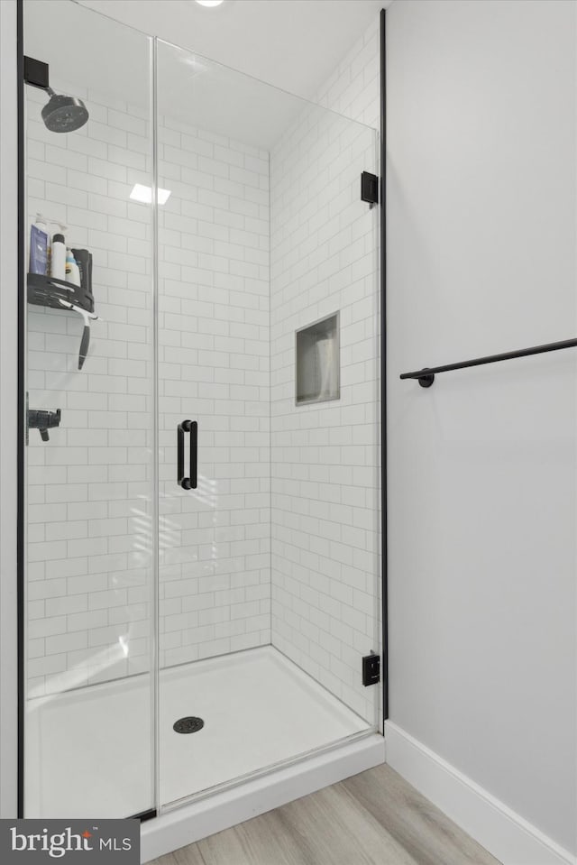 bathroom featuring walk in shower and hardwood / wood-style flooring