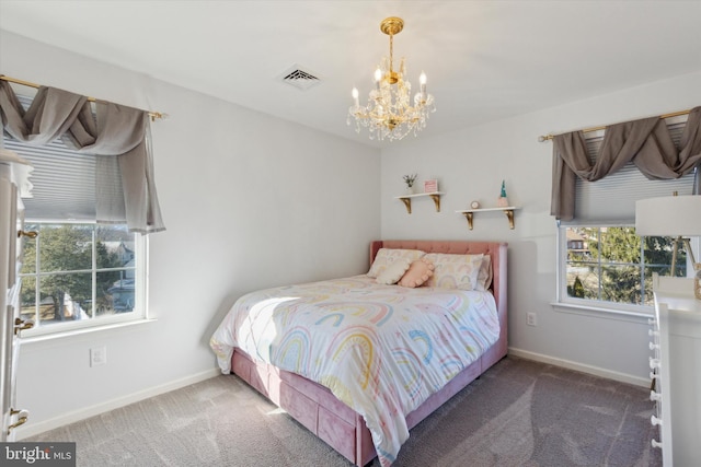 carpeted bedroom with a notable chandelier