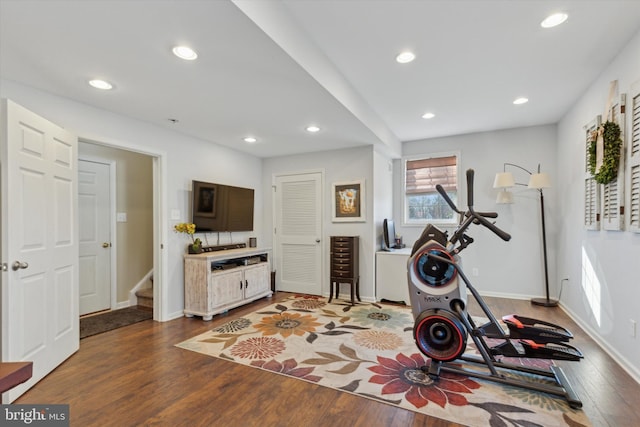 exercise room with wood-type flooring