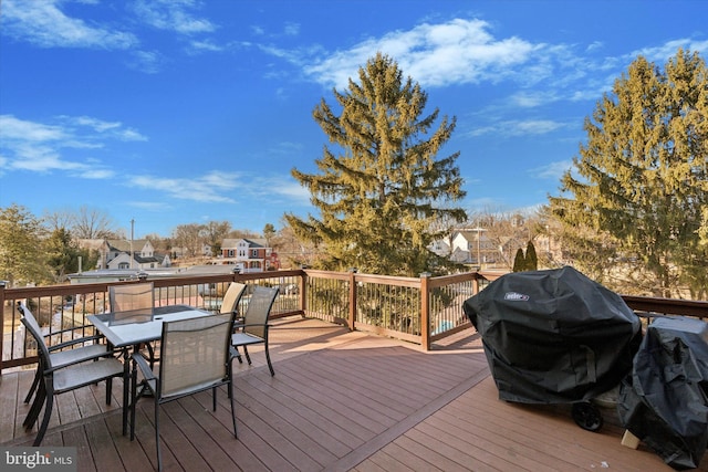 wooden terrace with a grill