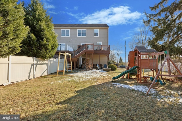 rear view of house featuring a yard and a playground