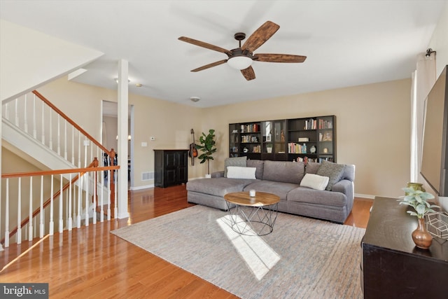 living room featuring ceiling fan and hardwood / wood-style floors