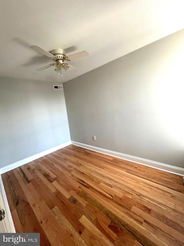 spare room featuring hardwood / wood-style flooring and ceiling fan