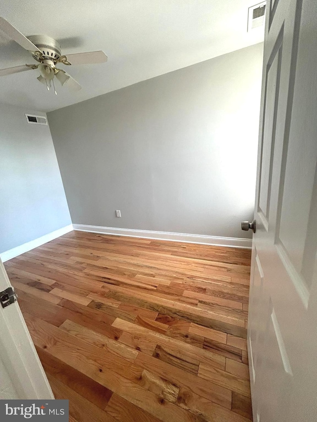 spare room featuring hardwood / wood-style floors and ceiling fan