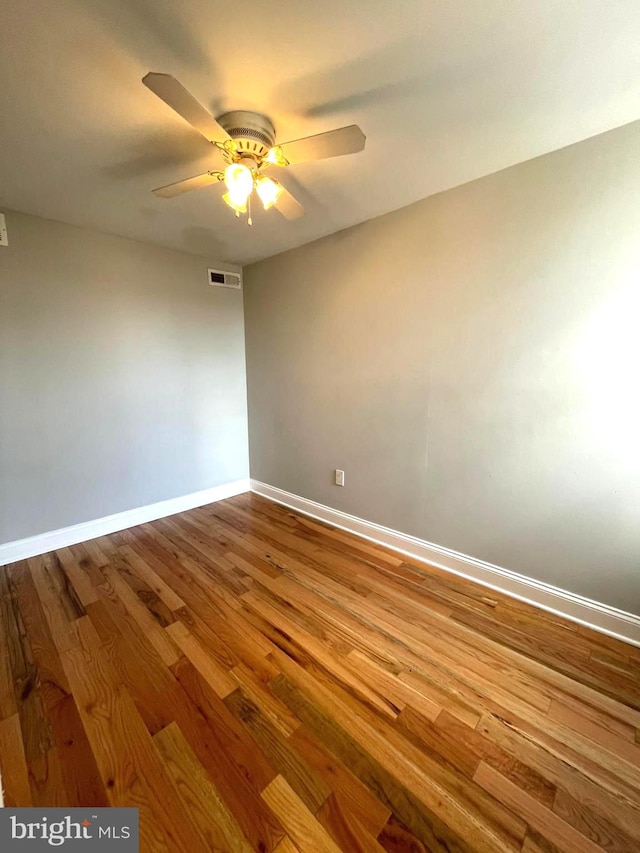 unfurnished room with hardwood / wood-style floors and ceiling fan