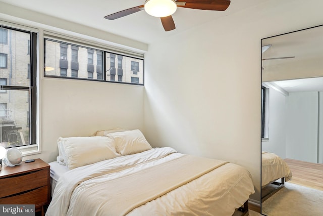 bedroom with ceiling fan and hardwood / wood-style flooring