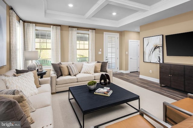 living room featuring coffered ceiling, hardwood / wood-style floors, ornamental molding, and beam ceiling