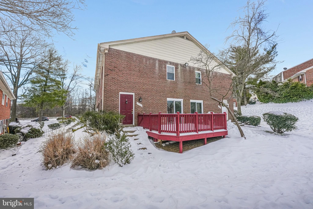 snow covered property featuring a deck