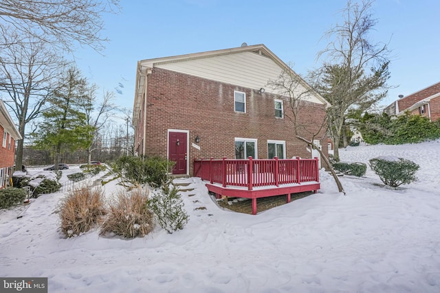 snow covered property featuring a deck