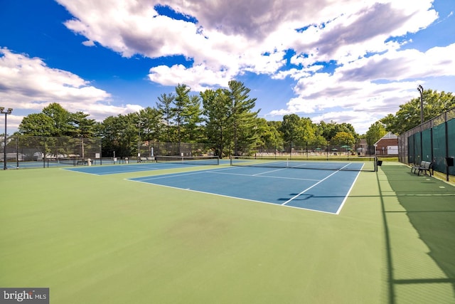 view of tennis court with basketball hoop