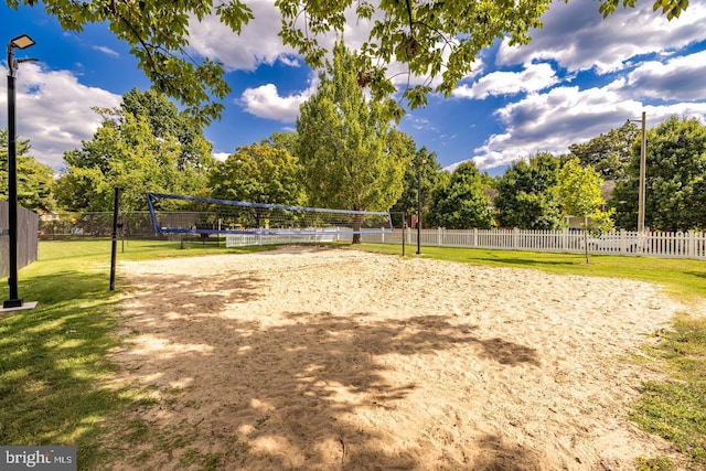 view of property's community with volleyball court and a yard