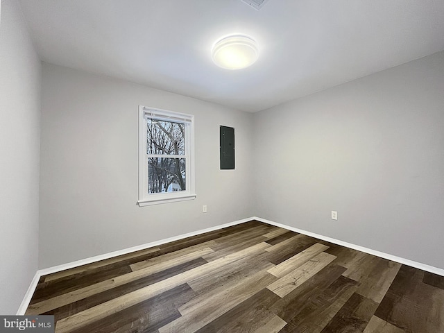 unfurnished room featuring hardwood / wood-style floors and electric panel