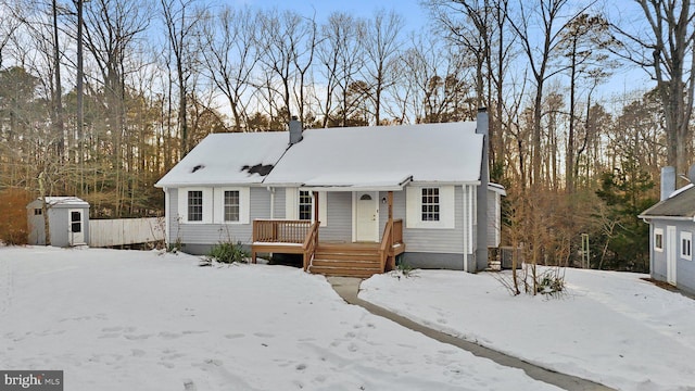 view of front of property featuring a shed