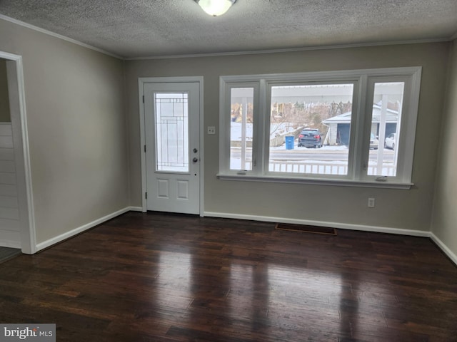 foyer featuring a textured ceiling, a wealth of natural light, and dark hardwood / wood-style floors