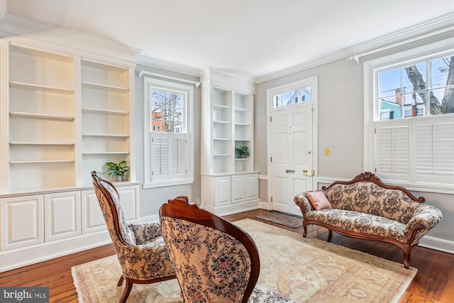 living area featuring ornamental molding, a healthy amount of sunlight, and dark hardwood / wood-style floors