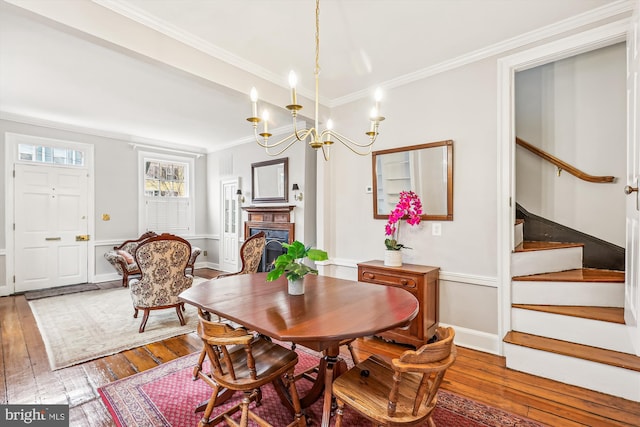 dining room with hardwood / wood-style floors and ornamental molding