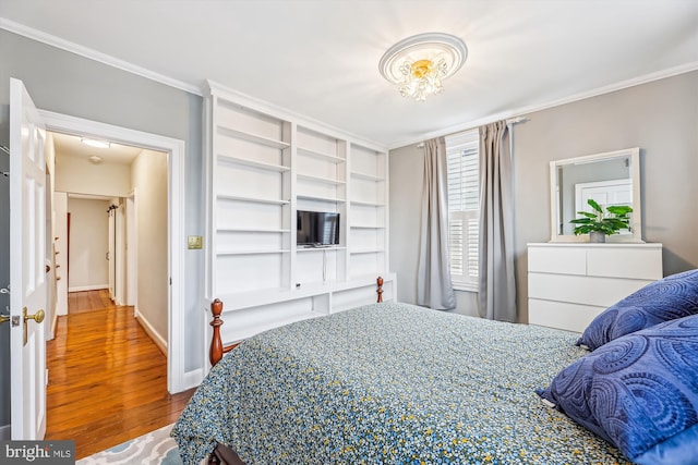 bedroom featuring crown molding and hardwood / wood-style flooring