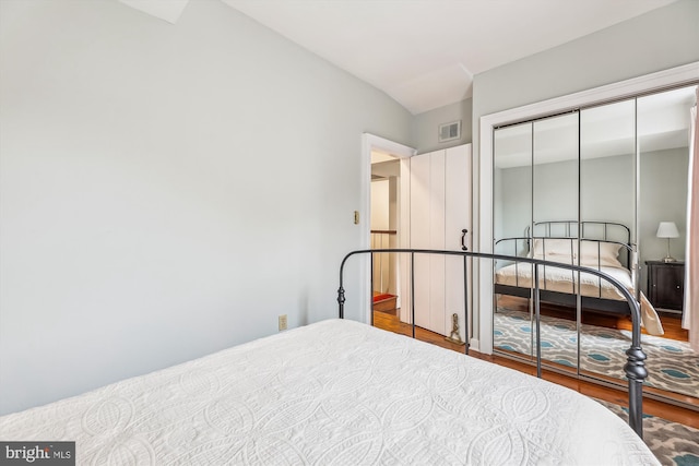 bedroom with hardwood / wood-style flooring and a closet