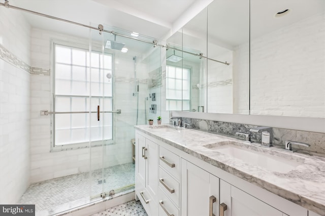 bathroom with vanity and a shower with shower door