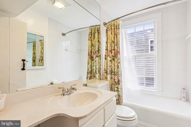 full bathroom featuring vanity, shower / tub combo, and toilet