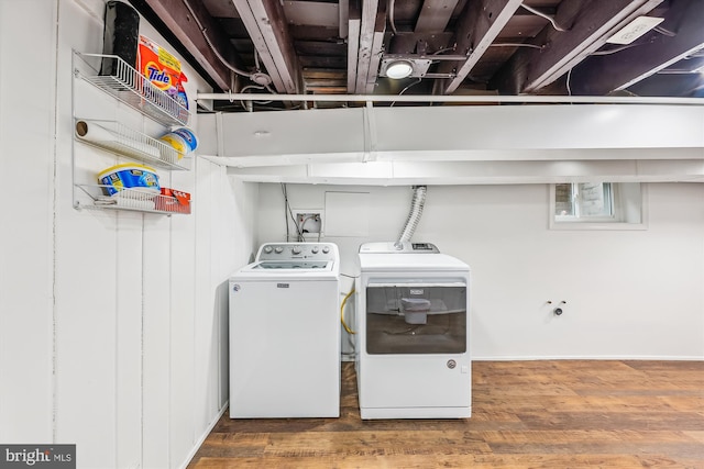 laundry area with independent washer and dryer and hardwood / wood-style floors