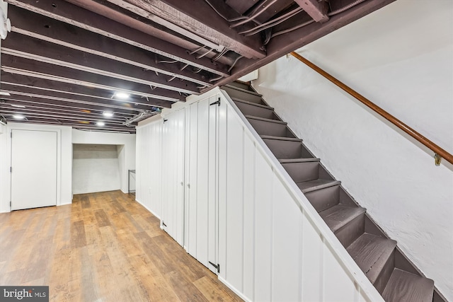 basement with light hardwood / wood-style flooring