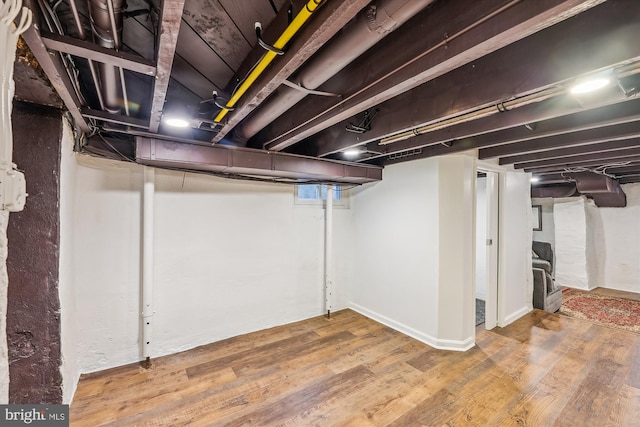 basement featuring hardwood / wood-style floors