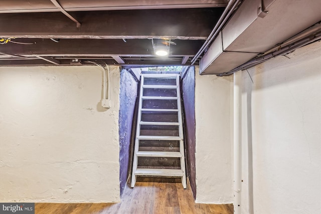 basement with hardwood / wood-style flooring