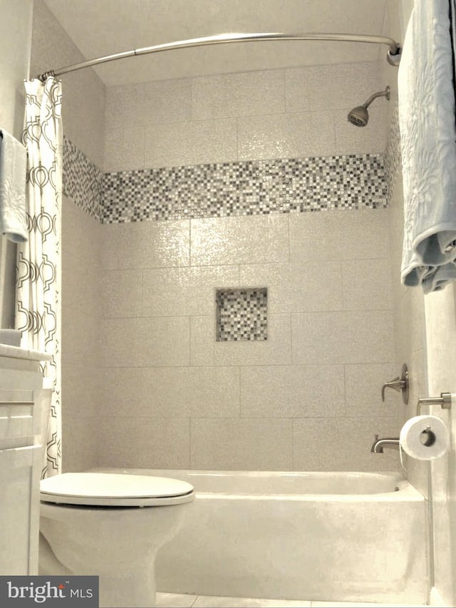 bathroom with toilet and shower / bath combo with shower curtain