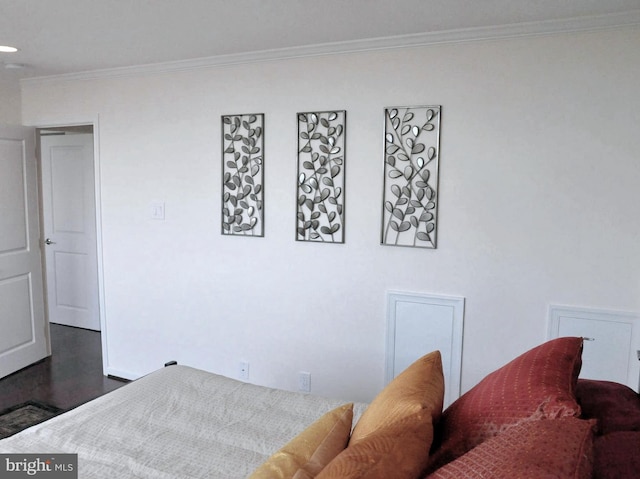 bedroom with crown molding and dark wood-type flooring