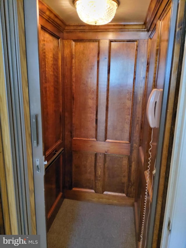 interior details featuring elevator and wood walls