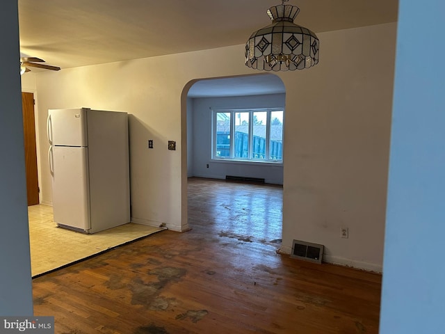 unfurnished dining area with ceiling fan and light hardwood / wood-style flooring