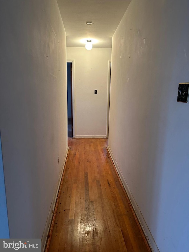 corridor with hardwood / wood-style floors