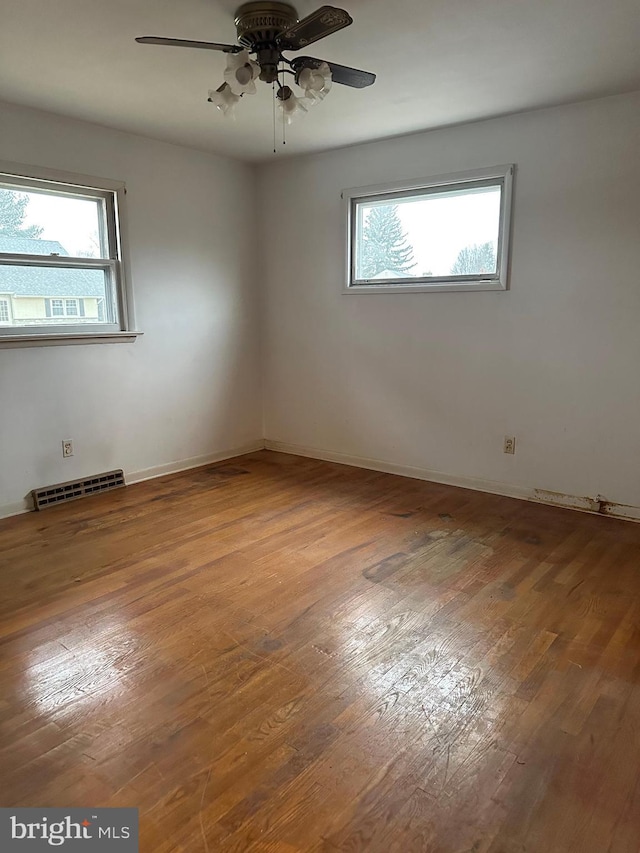 empty room featuring ceiling fan and wood-type flooring