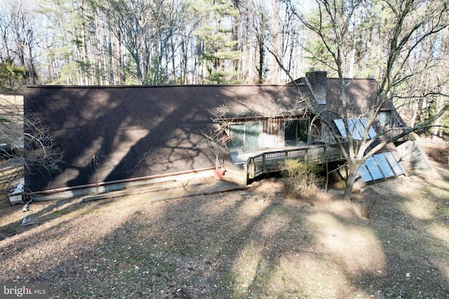 view of side of property featuring a chimney