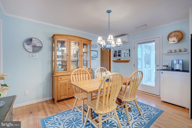 dining room with ornamental molding, a wall mounted AC, and light hardwood / wood-style floors