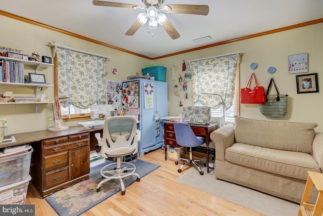 office space featuring ornamental molding, ceiling fan, and light wood-type flooring