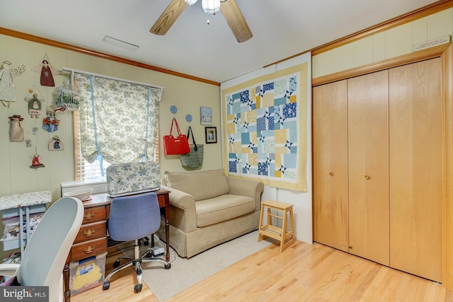 office space featuring crown molding, ceiling fan, and light wood-type flooring