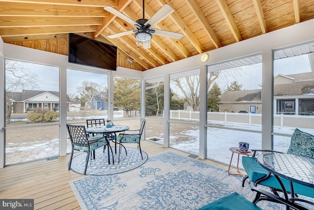 sunroom / solarium featuring vaulted ceiling with beams and ceiling fan