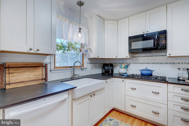 kitchen with sink, white cabinetry, white dishwasher, pendant lighting, and stainless steel gas stovetop