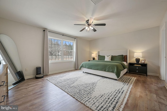 bedroom with ceiling fan and wood-type flooring