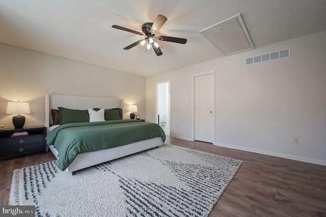 bedroom with dark hardwood / wood-style flooring, ceiling fan, and ensuite bathroom