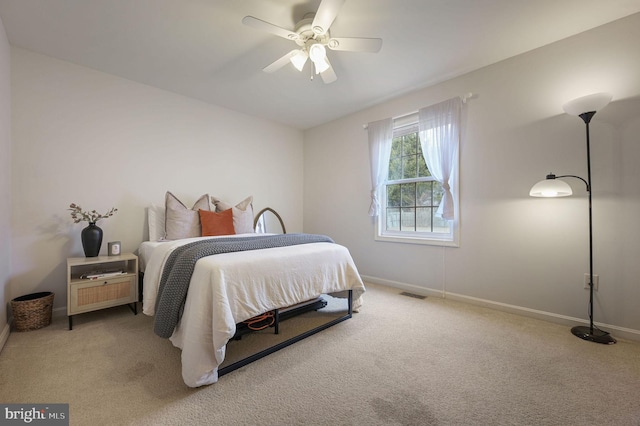 bedroom with light colored carpet and ceiling fan