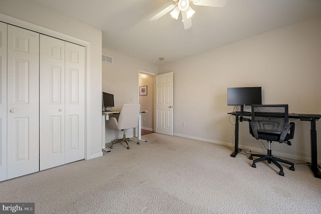 carpeted office with ceiling fan