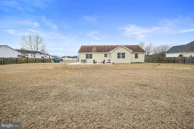 rear view of house featuring a yard and a patio area