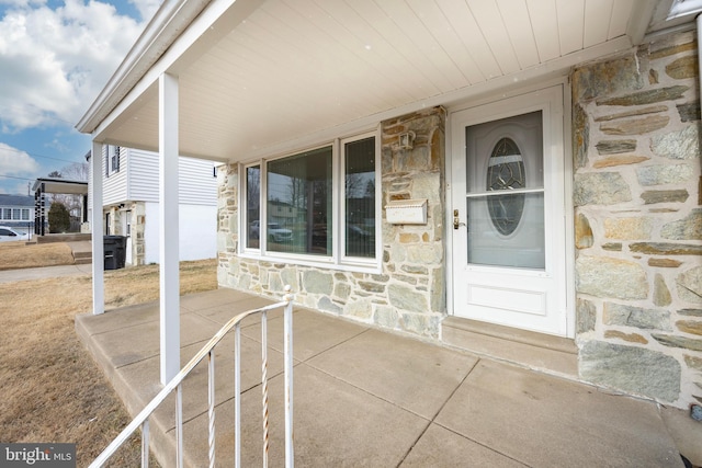 view of exterior entry featuring covered porch