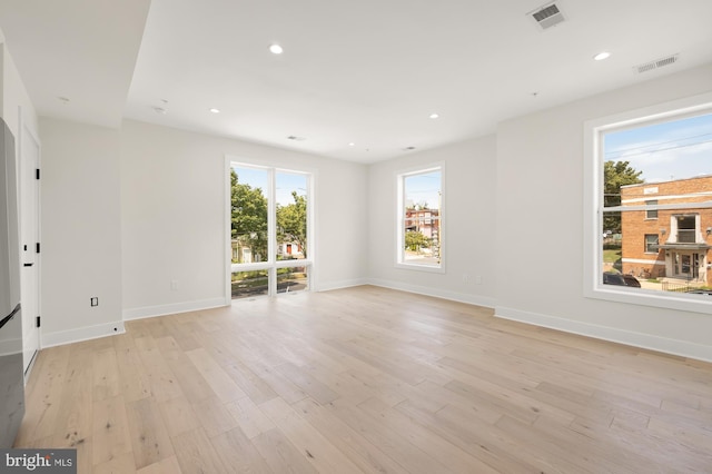 spare room with light hardwood / wood-style floors