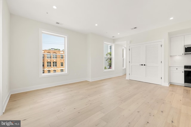 unfurnished living room featuring light hardwood / wood-style flooring