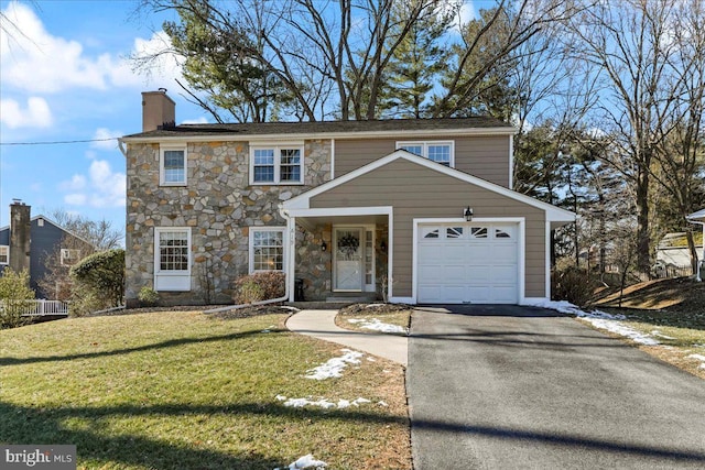 front of property featuring a front lawn and a garage