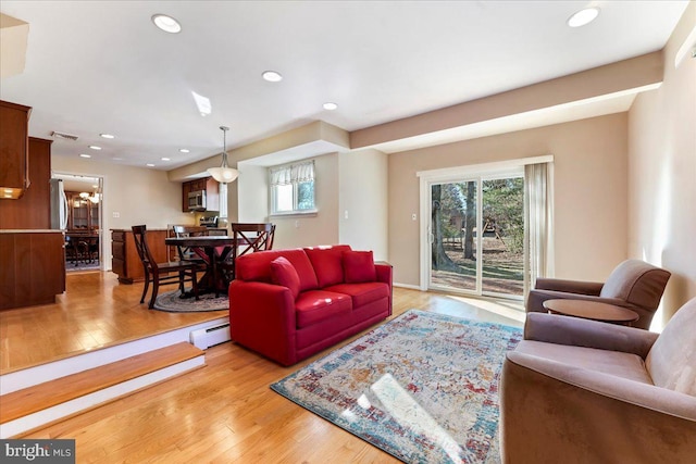 living room featuring baseboard heating and light wood-type flooring